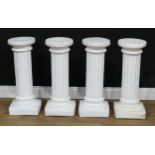 A set of four composition statuary pedestals, 66.5cm high, the top 24.5cm diameter (4)