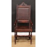 An oak wainscot armchair, shaped and pierced cresting, raised and fielded panel back, shaped arms