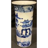 A Chinese blue and white flared cylindrical vase, painted with a landscape of pagodas, a bridge