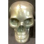 A cast metal model of a human skull, with articulated lower jaw, 9.5cm high