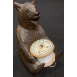 A Black Forest sewing cotton reel holder, carved as a bear, early 20th century