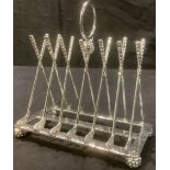A plated novelty toast rack, the uprights modelled as crossed golf clubs16.5cm high, 18cm high