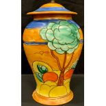 An Art Deco Crown Devon inverted baluster table lamp, tube lined with tall trees and ripe oranges,