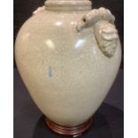 A large Chinese crackle glaze vase, lion mask handles, hardwood stand, 43cm high overall