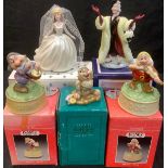 A Royal Doulton Disney figure, Cruella Deville, boxed; a Schmid Disney figure, Cinderella in Wedding