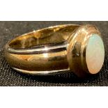 A 9ct gold ring, set with a single polished opal oval cabochon, size M, 3.7g