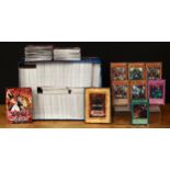 A large collection of Konami Yu-Gi-Oh! trading cards, some with silver and gold foil lettering to