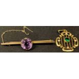 A 9ct gold bar brooch, set with a single faceted amethyst, 4.8g; an unmarked 9ct gold pendant, set