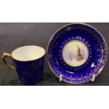 A Royal Crown Derby cabinet cup and saucer, painted panels of sailing boats on a blue and gilt