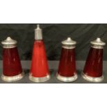 An unusual Edwardian silver mounted red glass four piece conical condiment set, Birmingham 1902/07
