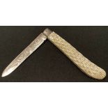 An Edwardian silver folding pocket fruit knife, the two-piece grip chequered and decorated with