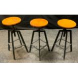 A set of three height adjustable bar stools, circular pine tops hollow bar legs, foot rest