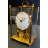 A mid 20th century Kundo atlas clock, brass four glass case