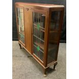 A mid 20th century mahogany display cabinet, the pair of glazed, leaded doors with malachite glass