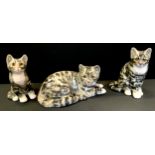 A Jenny Winstanley pottery tabby cat, seated, number 3, 21cm high, others number 4, 22cm high,