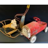 A mid 20th century tin plate pedal car, probably Pilgrim Comet, red body, white grill, white plastic