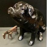 A large model seated Pig, in black, 43cm high; a metal horse