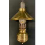 An early 20th century wall mounted adjustable brass oil lamp, converted for use with electricity,