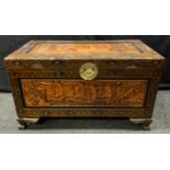 An Eastern camphor wood blanket chest, carved in relief on all sides with scenes depicting