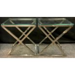 Eichholtz - a pair of 'Criss Cross polished steel rectangular side tables, the X frame tubular table
