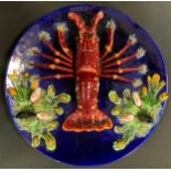 A Caldas Da Rainha majolica dish, typically decorated in the Palissy style with a lobster and