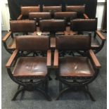 A set of ten X-frame oak chairs, brown leatherette upholstery metal studded boarders, 86cm high x