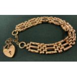 A 9ct rose gold fancy link gate bracelet, padlock clasp, 17.5g gross