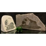 A Siku Allooloo carved stone tablet, of an Inuit figure kissing a Seal, 13cm x 24cm; another