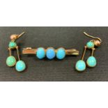 An early 20th century Victorian style turquoise triple cabochon bar brooch, unmarked yellow metal