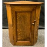 A Nigel Griffiths style oak corner cupboard, 76cm tall x 59cm wide x 39cm deep.