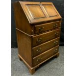 A Bevan funnell Reprodux oak bureau of small proportions, 94.5cm high, 58cm wide, 41cm deep.