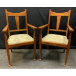 A pair of early 20th century Arts and Crafts oak armchairs, c.1900, (2).