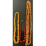 A Cherry amber coloured graduated bead necklace, from 24mm to 9mm diameter, 44cm long; others