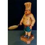 A large novelty figure modelled as a Chef holding a frying pan, shaped base, 75cm high