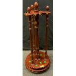 A mahogany revolving snooker cue stand, fitted for nine cues, rests, turned supports, circular base,