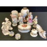 A German figural oil lamp, c.1880; a pair of German figures, Papa and Mama; a pair of Derby figures,