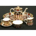 A Royal Crown Derby 1128 miniature tea service, on oval tray, teapot, milk jug, sugar bowl, teacup