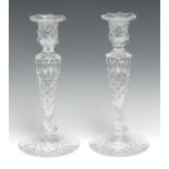 A substantial pair of cut-glass candlesticks, crenelated drip pans above faceted sconces, tapering