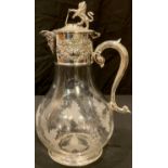 A clear glass claret jug, engraved with fruiting vine, silver plated cover with mask spout, vacant