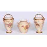 A pair of Royal Worcester elongated baskets, printed and painted with wild flowers, gilt handles,