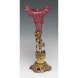 A 19th century Rococo Revival gilt-metal figural spill holder, cranberry glass trumpet-shaped
