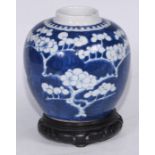 A Chinese ovoid ginger jar, painted in tones of underglaze blue with blossoming prunus on a ground