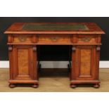 A late 19th century walnut accented desk, rectangular top with inset tooled and gilt writing surface