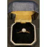 An 18ct gold and platinum illusion set diamond solitaire ring, size J/K, 2.1g, boxed