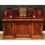 A Victorian mahogany sideboard, half-gallery carved and applied with C-scrolls and scrolling