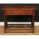 An oak side table, slightly oversailing top above a long frieze drawer, the front inlaid in the