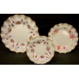 A Royal Crown Derby Royal Antoinette pattern shaped circular plate, a similar tea plate, seconds;