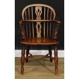 A 19th century elm Windsor elbow chair, low hoop back, shaped and pierced splat, one-piece mid-rail,