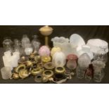 A brass oil lamp, assorted glass lamp shades, some opaque, oil lamp fittings and parts, clear