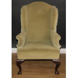 A George II style wingback armchair, cabriole forelegs, 117cm high, 77cm wide, the seat 48cm wide